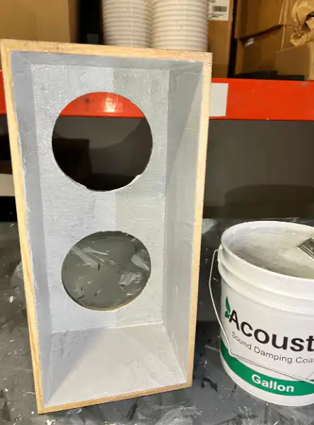 This absorption keeps the sound clear by preventing the muddiness that happens when sound waves randomly bounce around inside a speaker. This image is the inside of the speaker cabinet with Acuost-X