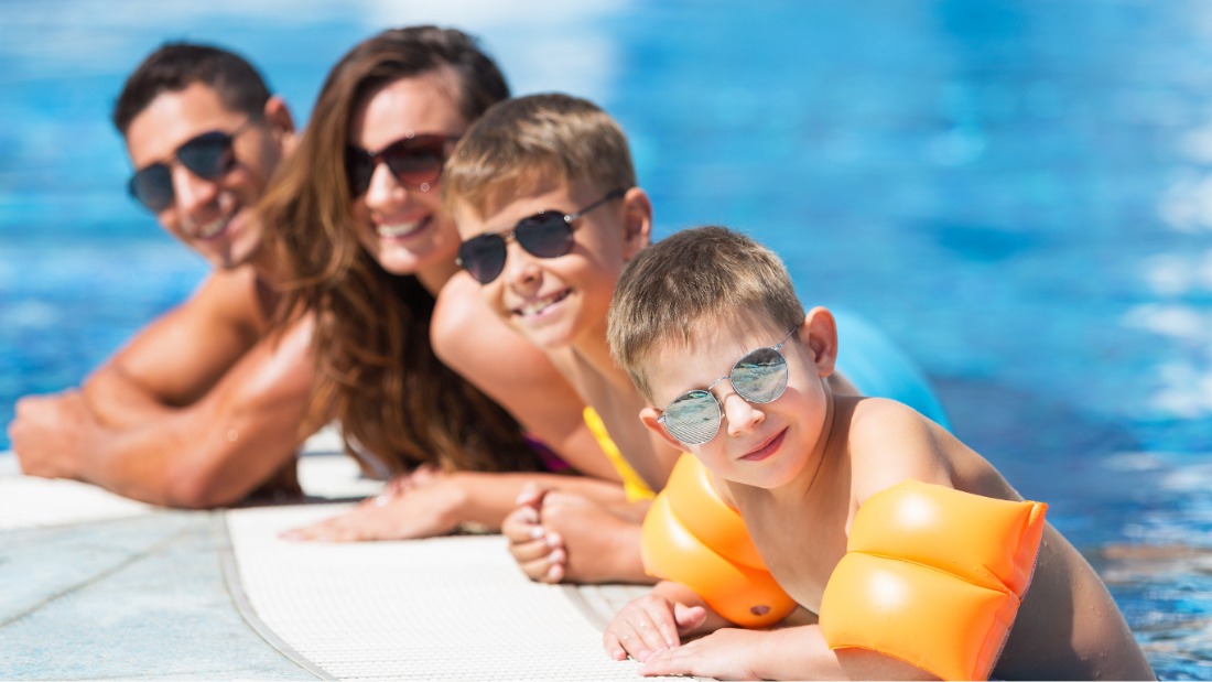 family enjoying pool
